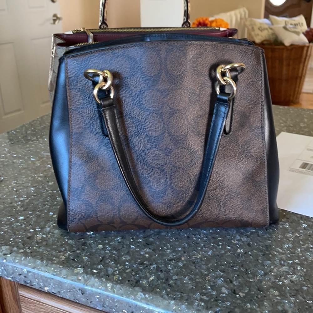 Black and brown leather coach hand bag